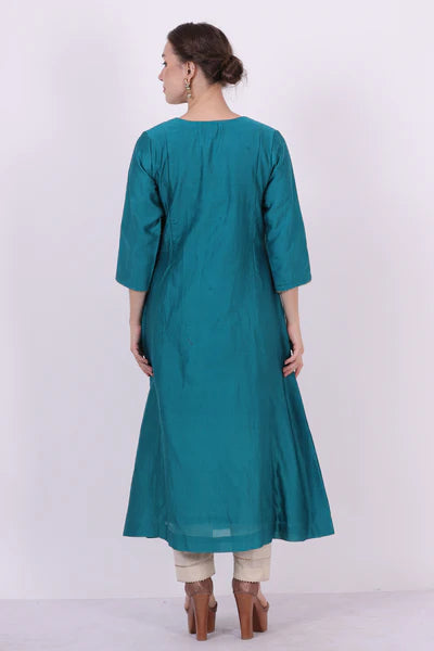 A woman standing and wearing Kaavya Turquoise Colored Shirt.
