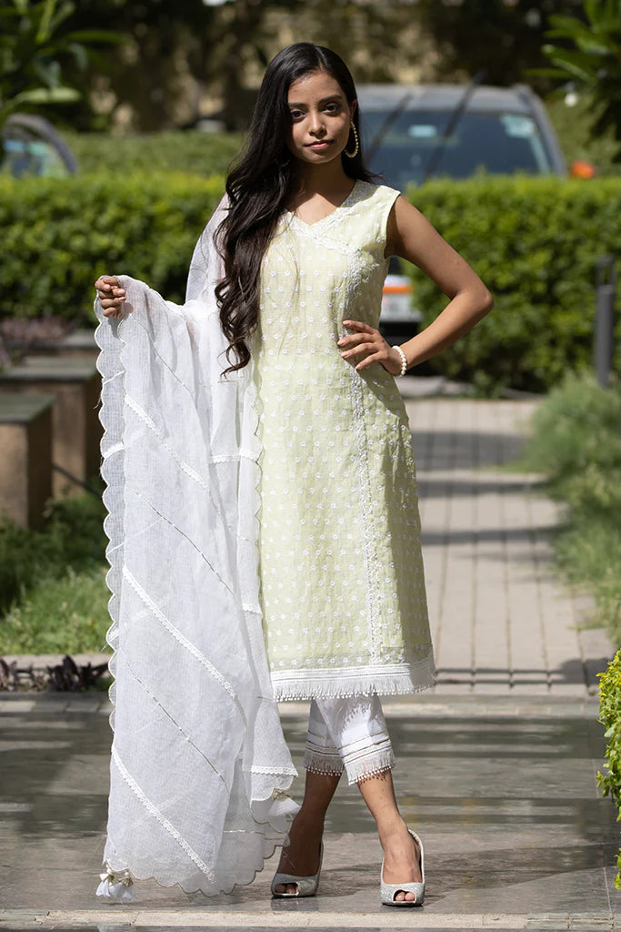 A woman wearing Kesar Green Colored Sleeveless Suit Set.