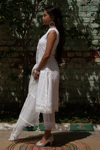A woman wearing Kesar Ivory Colored Sleeveless Suit Set.