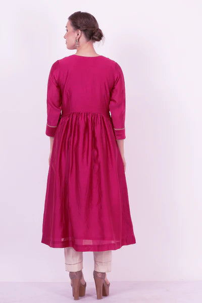 A woman standing and wearing Padma Wine Colored Ethnic Wear.