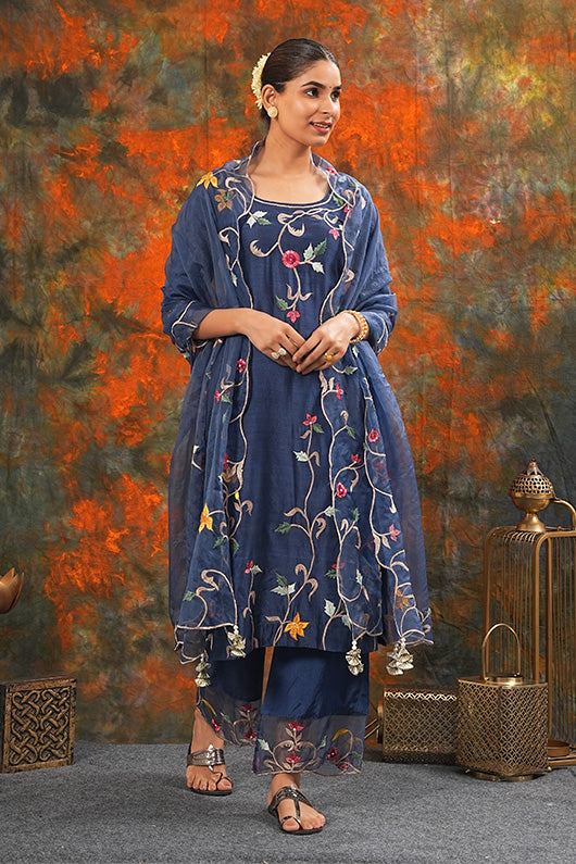 A woman standing and wearing Sarla Midnight Blue Colored Suit Set.