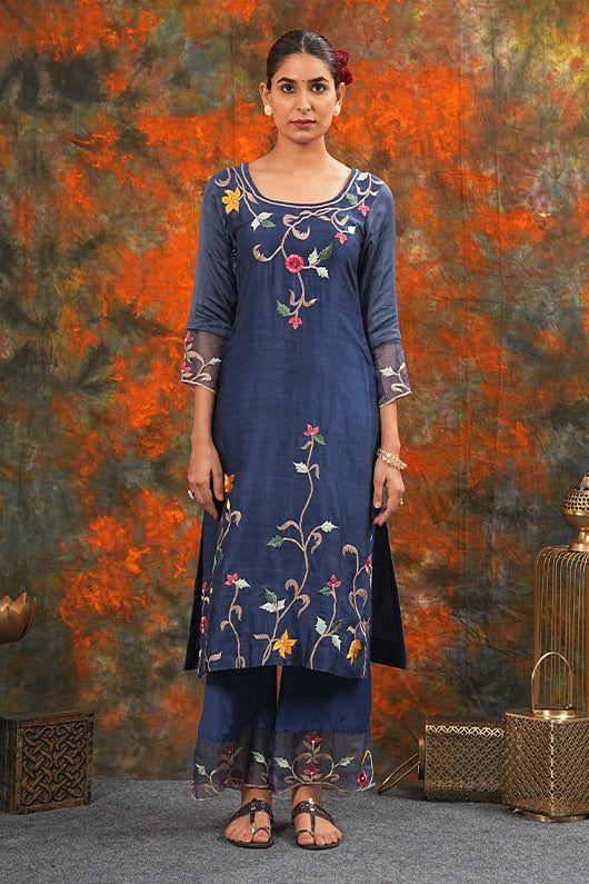 A woman standing and wearing Sarla Midnight Blue Colored Suit Set.