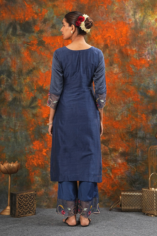 A woman standing and wearing Sarla Midnight Blue Colored Suit Set.