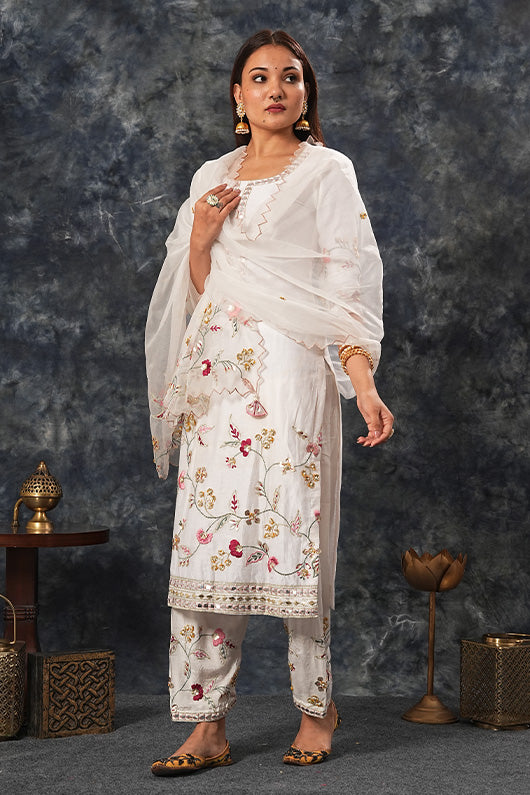 A woman wearing Siya Collection Ivory Colored Suit Set.