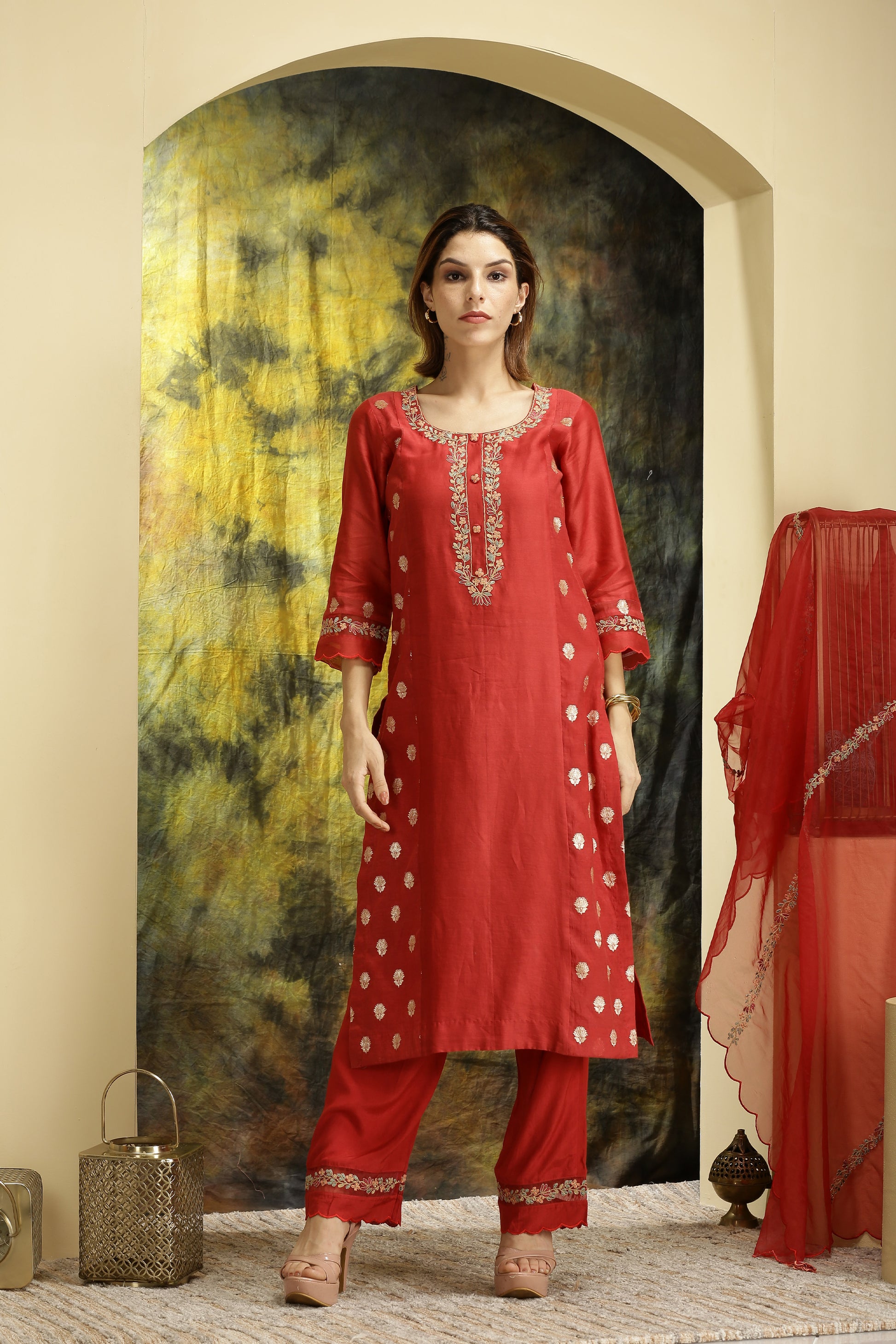 A woman wearing Meenakshi Collection Red Colored Suit Set.