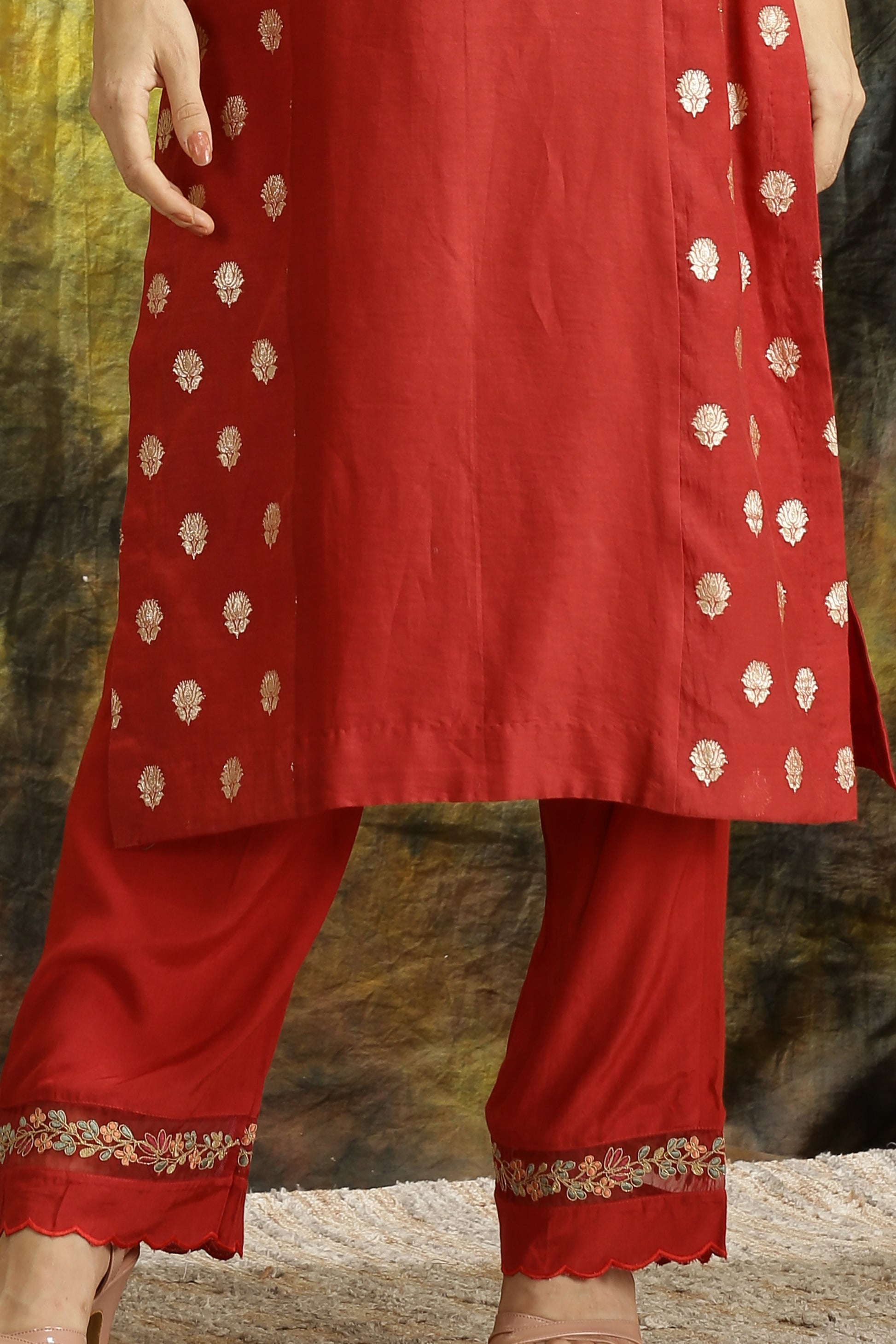 A woman wearing Meenakshi Collection Red Colored Suit Set.