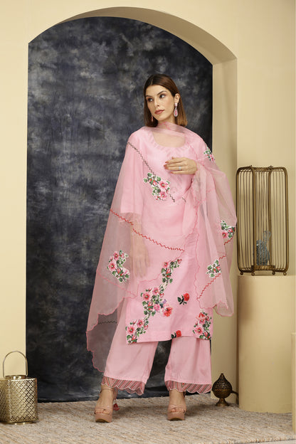 A woman standing and wearing Vaidehi Pink Colored Suit Set.