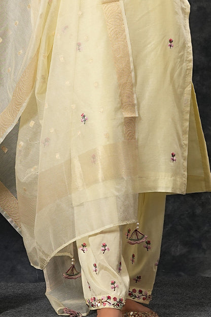 A woman standing and wearing Saumya Ivory Colored Suit Set.