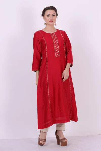 A woman standing and wearing Kaavya Red Colored Shirt.