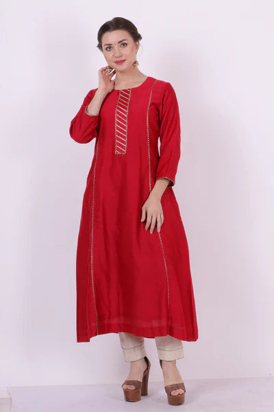 A woman standing and wearing Kaavya Red Colored Shirt.