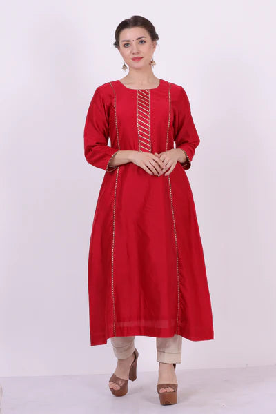 A woman standing and wearing Kaavya Red Colored Shirt.