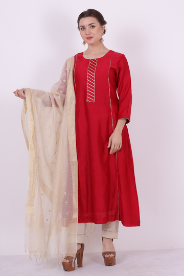 A woman standing and wearing Kaavya Red Colored Shirt.