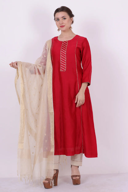 A woman standing and wearing Kaavya Red Colored Shirt.