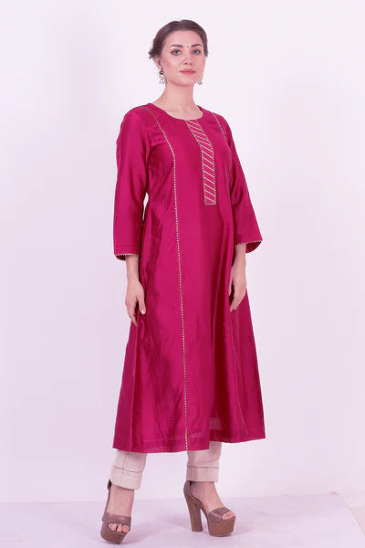 A woman standing and wearing Kaavya Wine Colored Shirt.