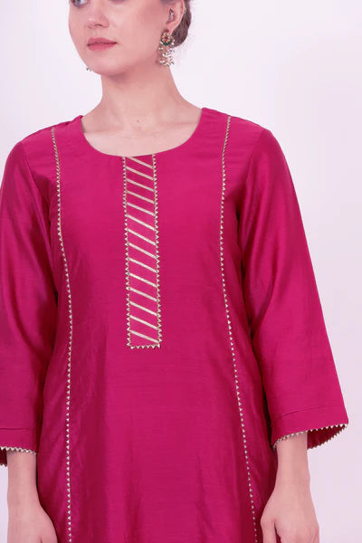 A woman standing and wearing Kaavya Wine Colored Shirt.