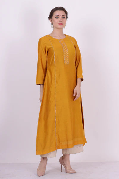 A woman standing and wearing Padma Yellow Colored Kurta Shirt.