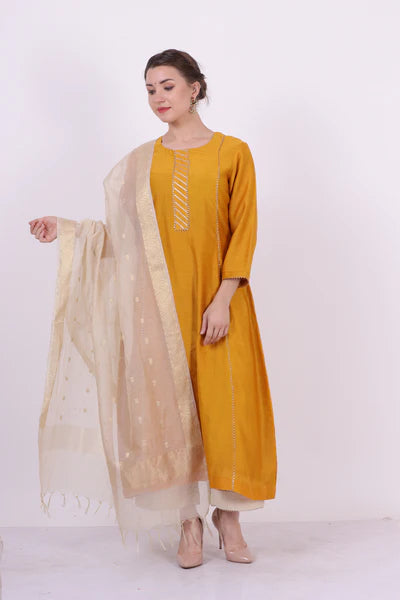 A woman standing and wearing Padma Yellow Colored Kurta Shirt.